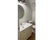 Powder room with modern fixtures featuring a round mirror and a sleek vanity sink at 324 Wild Horse Ln, Mount Pleasant, SC 29464