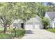 Charming home featuring a two-car garage, black shutters, and a well-manicured lawn at 350 Arlington Dr, Charleston, SC 29414