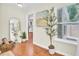 Hallway with wood floors, art, decor, and window with natural light at 350 Arlington Dr, Charleston, SC 29414
