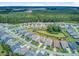 Aerial view of homes and neighborhood featuring landscaped yards and sidewalks with large wooded area in background at 366 Tupelo Lake Dr, Summerville, SC 29486