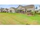 Wide shot of backyards with outdoor entertaining spaces and beautifully landscaped gardens at 366 Tupelo Lake Dr, Summerville, SC 29486