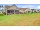 Expansive backyard with a well-manicured lawn, complemented by lovely screened in porches and landscaping at 366 Tupelo Lake Dr, Summerville, SC 29486