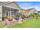 Lovely backyard with a stone retaining wall, lush green grass, and an inviting outdoor living area at 366 Tupelo Lake Dr, Summerville, SC 29486