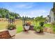 Beautifully landscaped backyard featuring stone retaining walls, colorful flower pots, and lush green grass at 366 Tupelo Lake Dr, Summerville, SC 29486