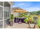 Inviting outdoor patio with comfortable seating under a large umbrella and views of the landscaped backyard at 366 Tupelo Lake Dr, Summerville, SC 29486