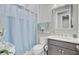 Cozy bathroom with a vanity, soft lighting and a shower with a blue curtain at 366 Tupelo Lake Dr, Summerville, SC 29486