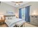 Comfortable bedroom with natural light from the window, enhanced by stylish blue curtains and a ceiling fan at 366 Tupelo Lake Dr, Summerville, SC 29486