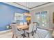 Contemporary dining room with hardwood floors, modern chandelier, wainscoting, and adjacent access to patio at 366 Tupelo Lake Dr, Summerville, SC 29486