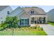 Inviting single-story home with beautifully landscaped front yard and covered porch at 366 Tupelo Lake Dr, Summerville, SC 29486