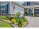 Landscaped home exterior featuring rock features, lighting, and colorful plants at 366 Tupelo Lake Dr, Summerville, SC 29486