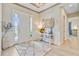 Inviting foyer with light wood floors, decorative rug, console table, and bright front door entrance at 366 Tupelo Lake Dr, Summerville, SC 29486