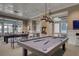 Spacious game room featuring a pool table, high ceilings, modern lighting, and neutral tones at 366 Tupelo Lake Dr, Summerville, SC 29486