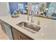 Modern kitchen island with stainless steel sink and faucet, and a view of the living area at 366 Tupelo Lake Dr, Summerville, SC 29486