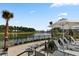 Relaxing lake view with lounge chairs and palm trees, perfect for unwinding at 366 Tupelo Lake Dr, Summerville, SC 29486