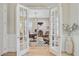 Home office featuring French doors, hardwood floors, neutral walls, and decorative light fixture at 366 Tupelo Lake Dr, Summerville, SC 29486