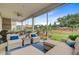 Spacious covered patio with comfortable seating, ceiling fan, and views of the lush green lawn at 366 Tupelo Lake Dr, Summerville, SC 29486