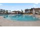 Inviting outdoor pool area with lounge chairs, umbrellas, and lush landscaping on a sunny day at 366 Tupelo Lake Dr, Summerville, SC 29486