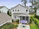 Aerial view showcasing the home's backyard, complete with a screened porch and patio area at 3998 Capensis Ln, Ravenel, SC 29470