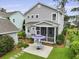Aerial view of backyard with screened porch, patio, and lush landscaping at 3998 Capensis Ln, Ravenel, SC 29470