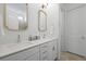 Bathroom featuring double sinks, white cabinetry and a large mirror at 3998 Capensis Ln, Ravenel, SC 29470