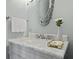 Elegant bathroom with marble countertop, decorative mirror, and a flower arrangement at 3998 Capensis Ln, Ravenel, SC 29470