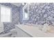 Stylish bathroom with floral wallpaper, a white vanity, and a decorative mirror at 3998 Capensis Ln, Ravenel, SC 29470
