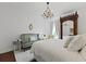 Charming bedroom with a crystal chandelier, dark wood floors, and a comfortable seating area at 3998 Capensis Ln, Ravenel, SC 29470