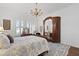 Serene bedroom with chandelier, wooden furniture and natural light at 3998 Capensis Ln, Ravenel, SC 29470