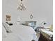 Bright bedroom with a crystal chandelier, white walls, and a comfortable seating area at 3998 Capensis Ln, Ravenel, SC 29470