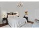 Inviting bedroom with white bedding, dark furniture, and a bright chandelier at 3998 Capensis Ln, Ravenel, SC 29470