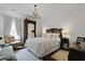 Elegant bedroom featuring a decorative chandelier, ornate armoire and plenty of natural light at 3998 Capensis Ln, Ravenel, SC 29470