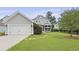 Charming property featuring a detached garage, lush lawn, and a lovely screened-in porch at 3998 Capensis Ln, Ravenel, SC 29470