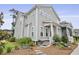 Beautiful two-story home with a welcoming front porch and meticulously landscaped front yard at 3998 Capensis Ln, Ravenel, SC 29470