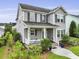 Well-maintained two-story home with a inviting front porch, surrounded by lush landscaping and healthy green lawn at 3998 Capensis Ln, Ravenel, SC 29470