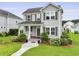 Beautiful two-story home featuring a landscaped yard, inviting porch, and classic architectural details for great curb appeal at 3998 Capensis Ln, Ravenel, SC 29470
