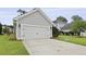 Detached garage with a well-maintained driveway and landscaping at 3998 Capensis Ln, Ravenel, SC 29470