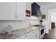 Modern kitchen with stainless steel appliances, custom hood, and granite countertops at 3998 Capensis Ln, Ravenel, SC 29470