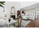 Bright living room with a fireplace, hardwood floors, and open kitchen concept at 3998 Capensis Ln, Ravenel, SC 29470