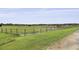 Pastoral fenced paddock with horses grazing on a lush green field at 3998 Capensis Ln, Ravenel, SC 29470