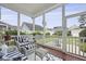 Relaxing screened-in porch with stylish seating and a view of the beautifully landscaped backyard at 3998 Capensis Ln, Ravenel, SC 29470