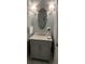 Charming powder room featuring marble countertop, elegant mirror, and sconces for a sophisticated touch at 3998 Capensis Ln, Ravenel, SC 29470
