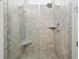 Modern shower with tile walls, dual shower heads, and a built-in bench at 3998 Capensis Ln, Ravenel, SC 29470