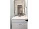Well-lit bathroom vanity with a framed mirror, stylish faucet, and convenient towel rack at 410 Yacht Harbor Ct # 410, Isle of Palms, SC 29451