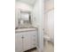 Well-lit bathroom features a granite countertop, white cabinetry and shower at 410 Yacht Harbor Ct # 410, Isle of Palms, SC 29451