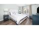 Serene bedroom features a large bed, matching bedside tables, and a view of the outside at 410 Yacht Harbor Ct # 410, Isle of Palms, SC 29451