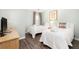 Bright bedroom features two twin beds, wood floors, and neutral wall color at 410 Yacht Harbor Ct # 410, Isle of Palms, SC 29451