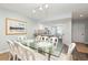 Dining room featuring a glass-top table, white chairs, and a view into the kitchen at 410 Yacht Harbor Ct # 410, Isle of Palms, SC 29451