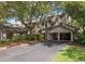 Exterior view of condos with carports, well-maintained landscaping, and mature trees at 410 Yacht Harbor Ct # 410, Isle of Palms, SC 29451