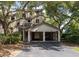 Exterior of a two-story home with a driveway and covered parking for two golf carts at 410 Yacht Harbor Ct # 410, Isle of Palms, SC 29451