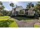 Exterior view of townhomes surrounded by mature trees and well-maintained landscaping at 410 Yacht Harbor Ct # 410, Isle of Palms, SC 29451